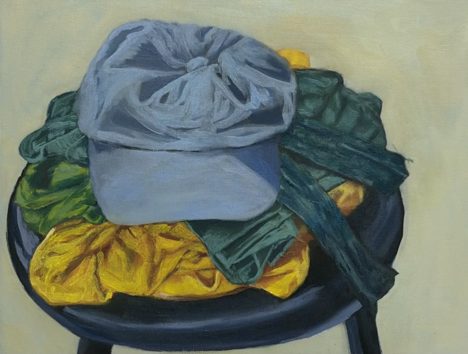 Still life of a cap and fabrics piled on a stool, oil on canvas